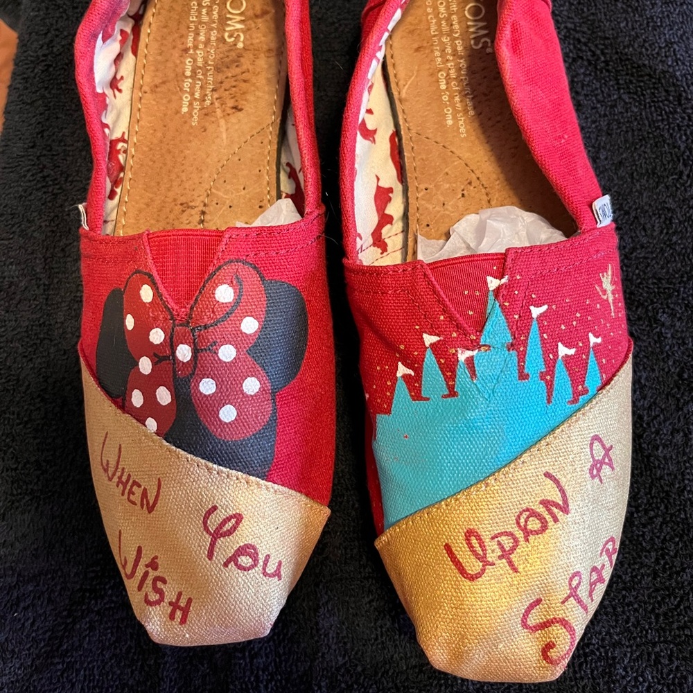 Painted Toms flats with Minnie Mouse & Cinderella’s Castle on them.
